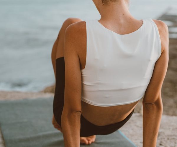 A woman laying out her yoga mat, ready to begin practice.